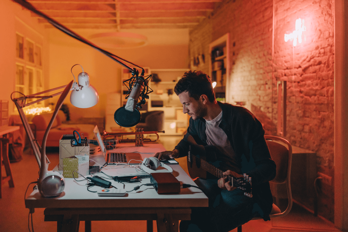 singer songwriter with guitar writing a song playing a song