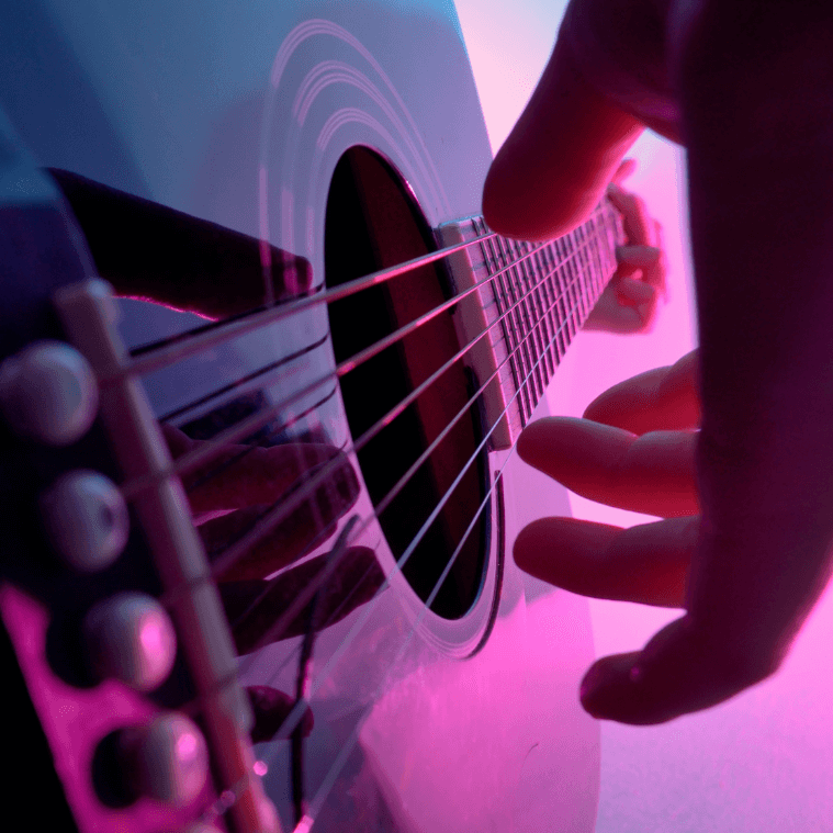 singer songwriter with guitar writing a song playing a song
